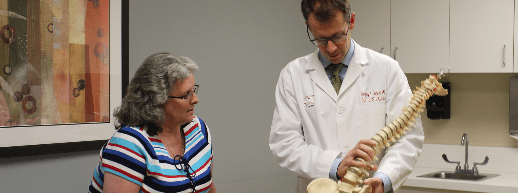 Dr. Poulter consulting patient about spine.