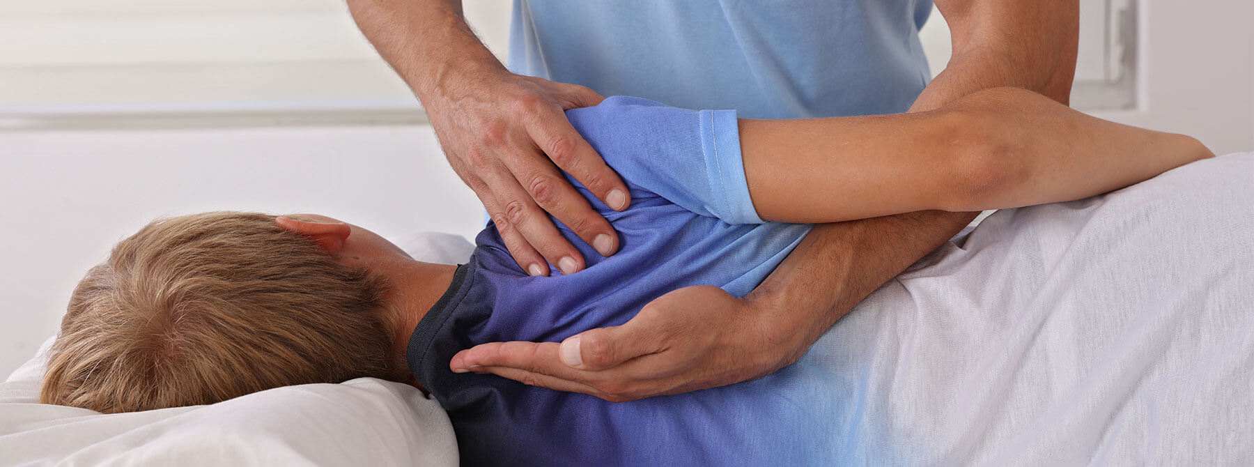 A doctor holding a child's back, providing scoliosis treatment in Brownsburg, IN