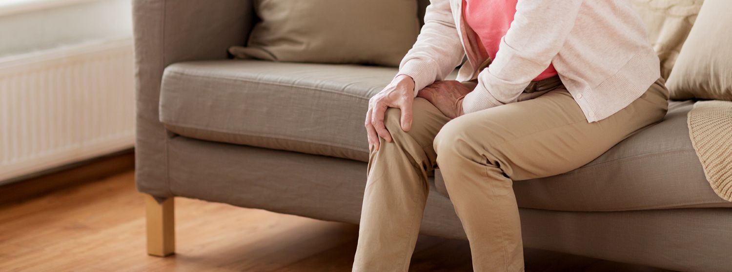 Woman Experiencing Knee Pain While Holding the Knee Joint