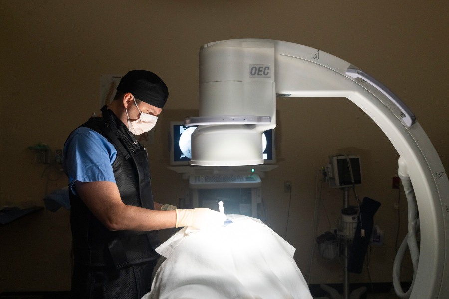 Medical professional performing an injection procedure in Brownsburg, IN