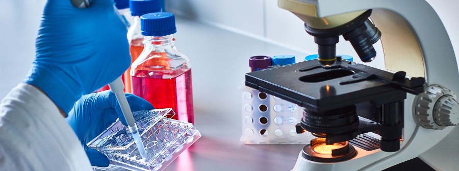 Laboratory setup with a gloved hand using a pipette in Brownsburg, IN